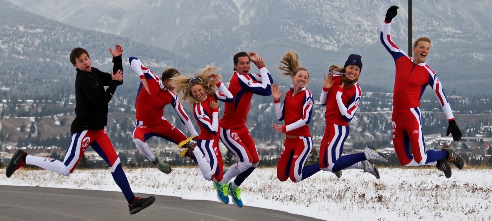 Skiers leaping in the air for for team photo